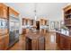 Gourmet kitchen with custom cabinets, a center island, granite countertops, and stainless steel appliances at 132 Loveland Way, Golden, CO 80401