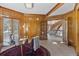 Wood-paneled office with natural light, a glass desk, and views of the curved staircase at 132 Loveland Way, Golden, CO 80401