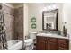 Full bathroom featuring a tiled shower, granite countertops, and elegant lighting at 2486 S Monroe St. St, Denver, CO 80210