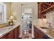 Butler's pantry with granite counters, cabinetry, and hardwood floors at 2486 S Monroe St. St, Denver, CO 80210
