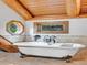 A clawfoot tub is centered beneath two windows in this stunning bathroom at 1000 Lodgepole Dr, Evergreen, CO 80439