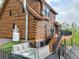 Beautiful log home with a hot tub and an outdoor staircase and deck at 1000 Lodgepole Dr, Evergreen, CO 80439