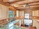 Charming kitchen with wood paneling, granite countertops, and vintage white oven at 1000 Lodgepole Dr, Evergreen, CO 80439
