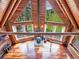 A-frame living room features a wood-burning stove and beautiful views of the surrounding forest at 1000 Lodgepole Dr, Evergreen, CO 80439