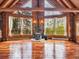 Inviting interior with wood floors, a stone fireplace, large windows, and high ceilings at 1000 Lodgepole Dr, Evergreen, CO 80439