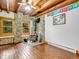 Inviting living room features wood-burning stove with stone surround and wood ceiling at 1000 Lodgepole Dr, Evergreen, CO 80439