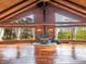 Beautiful interior featuring wood floors, a stone fireplace, large windows with views, and vaulted ceilings at 1000 Lodgepole Dr, Evergreen, CO 80439