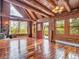Interior with wood floors, log walls, vaulted ceilings, lots of natural light, and a deck overlooking the landscape at 1000 Lodgepole Dr, Evergreen, CO 80439