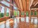 Open interior with wood floors, a stone fireplace, vaulted ceilings, and access to the outside at 1000 Lodgepole Dr, Evergreen, CO 80439