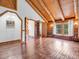 Spacious living area with hardwood floors and exposed wood beams throughout at 1000 Lodgepole Dr, Evergreen, CO 80439