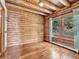 Cozy log cabin room with natural light streaming through the windows at 1000 Lodgepole Dr, Evergreen, CO 80439