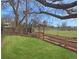 A lovely backyard with a well-manicured lawn, garden beds, and a charming wooden gate at 6501 Welch Ct, Arvada, CO 80004