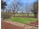 A beautiful backyard featuring a lush lawn, charming garden beds, and a stone pathway at 6501 Welch Ct, Arvada, CO 80004
