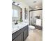 Modern bathroom with sleek black fixtures, a glass-enclosed shower, and stylish decor for a spa-like experience at 6501 Welch Ct, Arvada, CO 80004