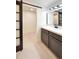 Bathroom featuring a sliding door that leads to a storage area and a modern vanity at 6501 Welch Ct, Arvada, CO 80004