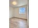 Bright bedroom featuring wood-look flooring and a window with outside view at 6501 Welch Ct, Arvada, CO 80004