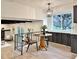 Inviting dining area with wood table, stylish pendant lighting, and a view of the lush outdoor scenery at 6501 Welch Ct, Arvada, CO 80004