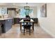 Spacious dining area with stainless steel refrigerator, dark cabinetry, and modern lighting at 6501 Welch Ct, Arvada, CO 80004