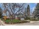 Street view of the home featuring attractive landscaping and a brick facade at 6501 Welch Ct, Arvada, CO 80004