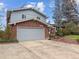 Two story home with brick facade, large driveway, and well manicured landscaping at 6501 Welch Ct, Arvada, CO 80004