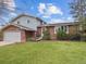 Charming two-story home with a well-maintained lawn, landscaping, and solar panels at 6501 Welch Ct, Arvada, CO 80004