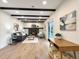 Cozy living room with exposed beam ceiling, modern fireplace, and comfortable seating, seamlessly connecting to the outdoors at 6501 Welch Ct, Arvada, CO 80004