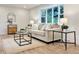Bright living room with a cozy sofa, stylish coffee table, and large bay window at 6501 Welch Ct, Arvada, CO 80004