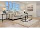 Cozy living room featuring a large bay window and comfortable seating arrangement at 6501 Welch Ct, Arvada, CO 80004