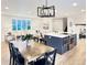 Open-concept living space with dining area, kitchen island, and cozy living room at 6501 Welch Ct, Arvada, CO 80004