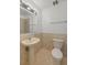 Cozy bathroom featuring a sink, toilet, and shower behind glass door at 6905 Mariposa St # C, Denver, CO 80221