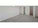 Spacious bedroom with neutral gray carpet and two entry/exit doors at 6905 Mariposa St # C, Denver, CO 80221