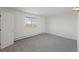Bright bedroom with neutral carpet, closet, and window providing natural light at 6905 Mariposa St # C, Denver, CO 80221