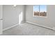 Well-lit bedroom featuring gray carpet, a large window, and a baseboard heater at 6905 Mariposa St # C, Denver, CO 80221