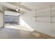 Single-car garage interior featuring white walls, concrete floors, and shelving at 6905 Mariposa St # C, Denver, CO 80221