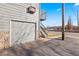 Exterior view of a one-car garage with stairs leading to a second-story balcony at 6905 Mariposa St # C, Denver, CO 80221