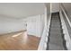 Inviting living room showcasing hardwood floors and staircase with neutral carpet at 6905 Mariposa St # C, Denver, CO 80221
