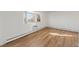 Bright living room featuring hardwood flooring and a bay window providing natural light at 6905 Mariposa St # C, Denver, CO 80221