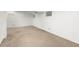 Unfinished basement with carpet, multiple small windows, and white painted walls at 1584 S Fraser Way, Aurora, CO 80012