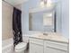 Bathroom features a vanity with storage, a tub and shower, and a mirrored wall at 1584 S Fraser Way, Aurora, CO 80012