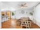 Open concept kitchen and dining area with hard wood floors, a bar top, and plenty of natural light at 1584 S Fraser Way, Aurora, CO 80012