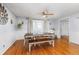 Dining room with decorative windmill, modern table with bench seating, and wood flooring at 1584 S Fraser Way, Aurora, CO 80012