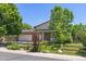 Charming two-story home with mature trees and a well-manicured lawn at 1584 S Fraser Way, Aurora, CO 80012