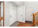 Entry featuring hardwood floors, white walls, staircase and access to multiple rooms at 1584 S Fraser Way, Aurora, CO 80012