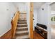 Home entry featuring wooden staircase, bench with shoe storage, and hardwood floors at 1584 S Fraser Way, Aurora, CO 80012