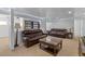 Finished basement living room with brown leather couches, led lighting, and a coffee table at 1584 S Fraser Way, Aurora, CO 80012