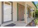 Inviting front porch with brick accents, decorative plants and hanging baskets at 1584 S Fraser Way, Aurora, CO 80012