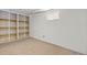 Finished basement room featuring shelving and a window at 1584 S Fraser Way, Aurora, CO 80012