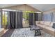 Relaxing sunroom with many windows, curtains, plush seating, and a stylish rug at 1584 S Fraser Way, Aurora, CO 80012