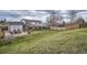 The expansive backyard includes a well-manicured lawn, an outdoor patio, and a deck for entertainment at 6592 S Cody Way, Littleton, CO 80123