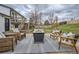 The backyard features a stylish patio with outdoor seating, a spacious deck, and a lush lawn at 6592 S Cody Way, Littleton, CO 80123